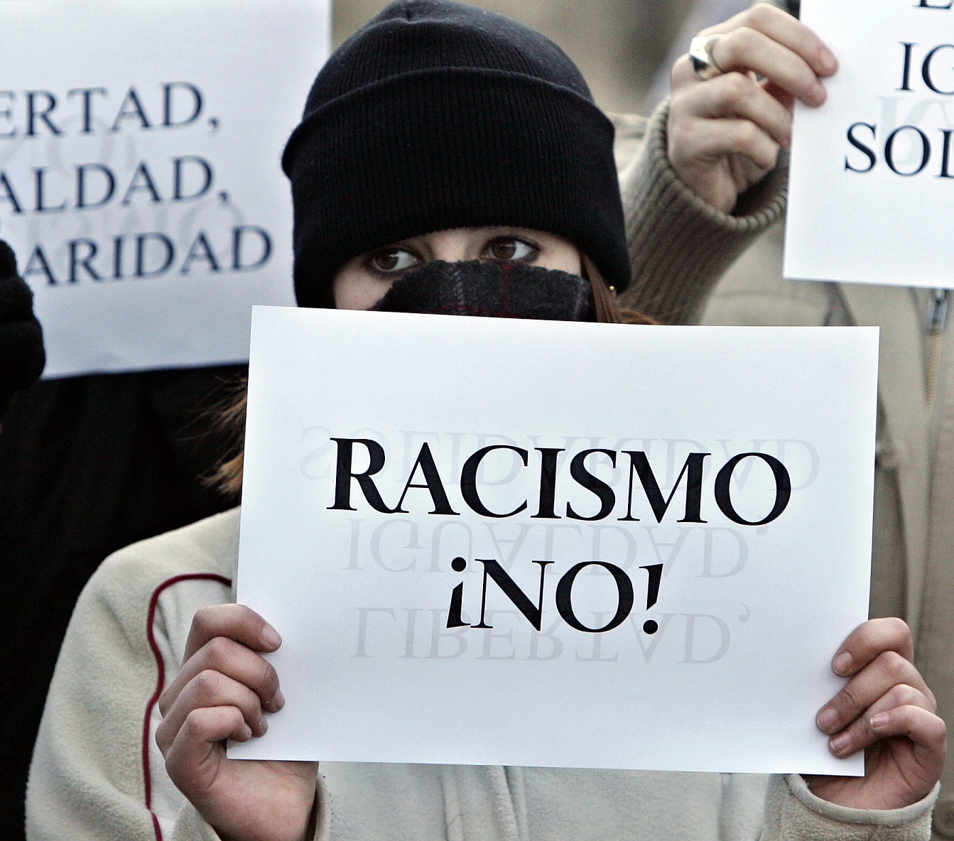 Una mujer posta una pancarta en la que se puede leer "Racismo ¡NO!" en una manifestación celebrada en Alcorcón en favor de los derechos humanos en...